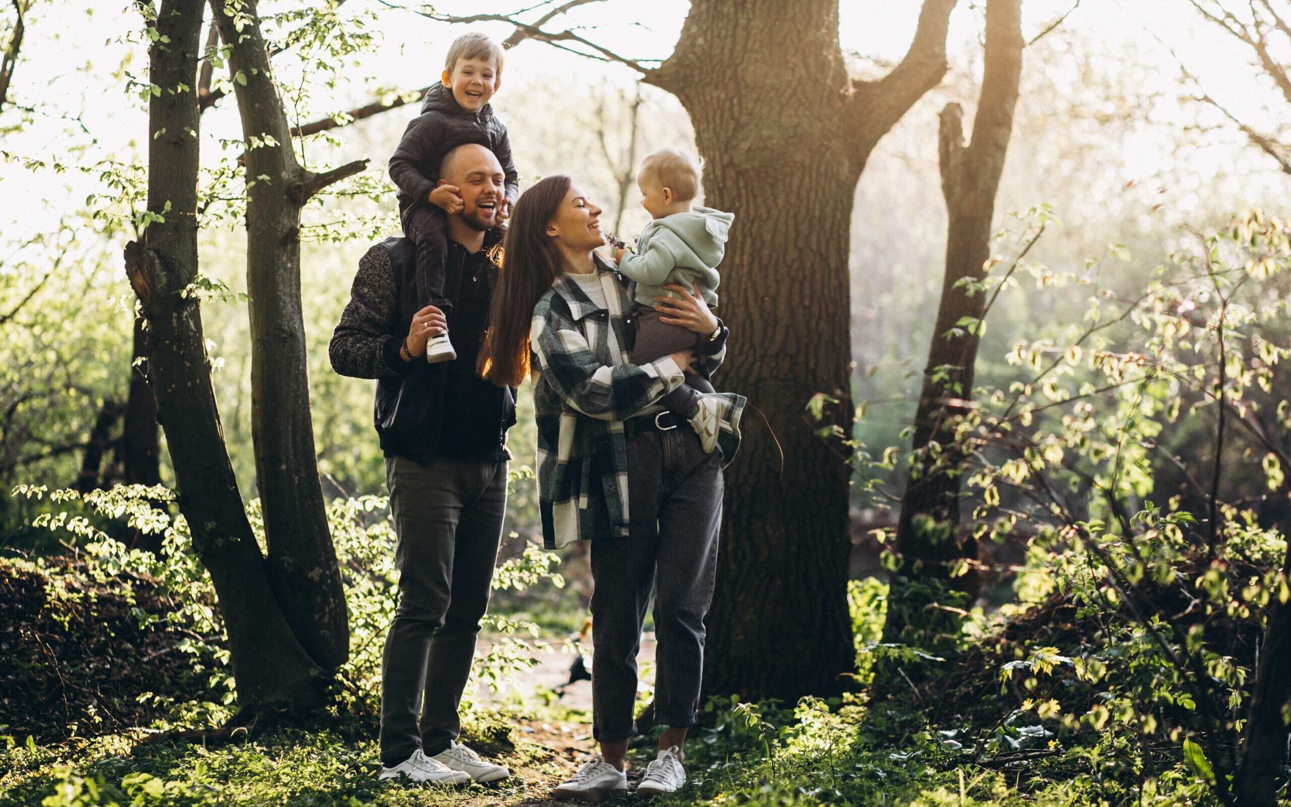 young-family-with-their-kids-having-fun-forest-compressed-1-scaled (1)
